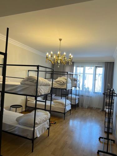 a room with four bunk beds and a chandelier at Velvet Vouge Hostel in Yerevan