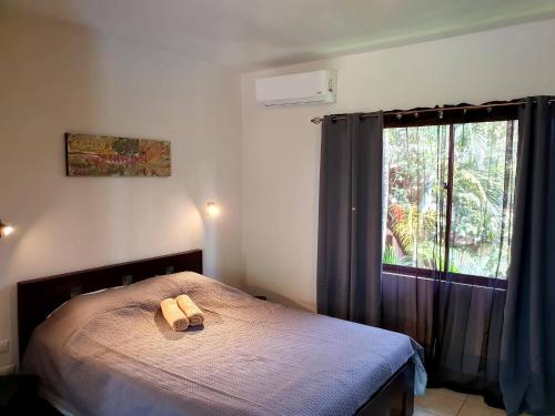 a bedroom with a bed with two towels on it at Apartment hotel Marina Loft 207 in Coco