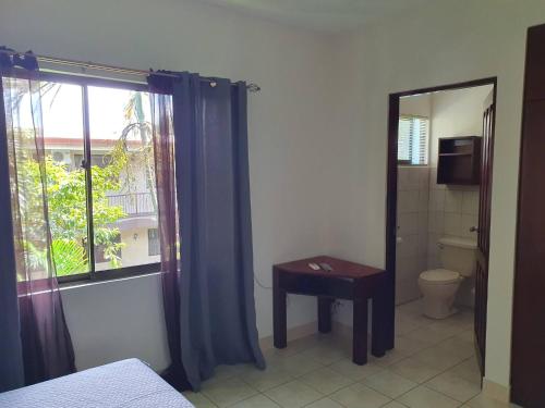 a room with a bathroom with a toilet and a window at Apartment hotel Marina Loft 207 in Coco