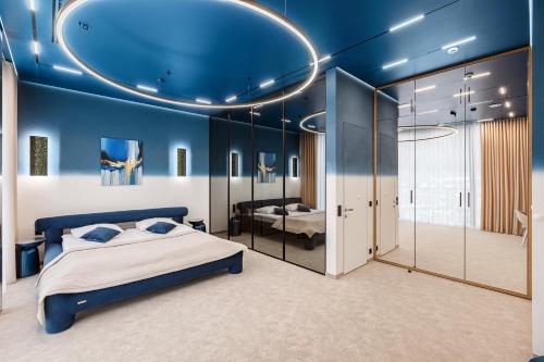 a bedroom with blue walls and a bed in a room at Tavel Hotel & SPA in Bukovel