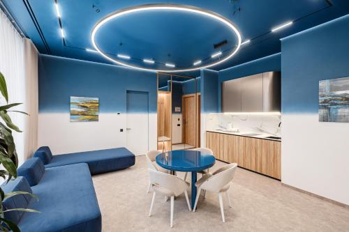 a blue living room with a blue table and chairs at Tavel Hotel & SPA in Bukovel