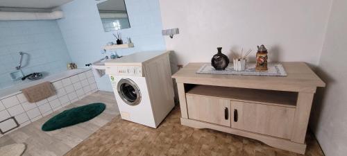 a bathroom with a washing machine and a sink at Haus Neuville in Medendorf, ruhige Lage in Bullange
