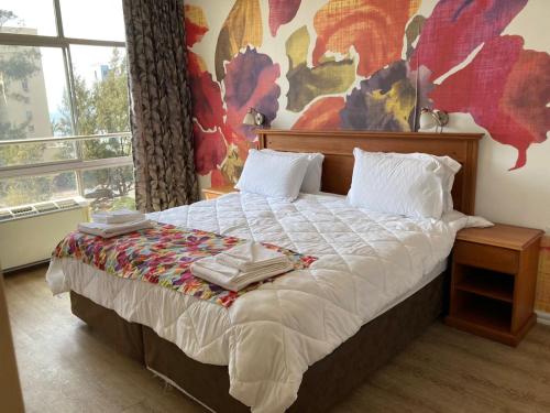 En eller flere senge i et værelse på Oceanic 24 North Beach