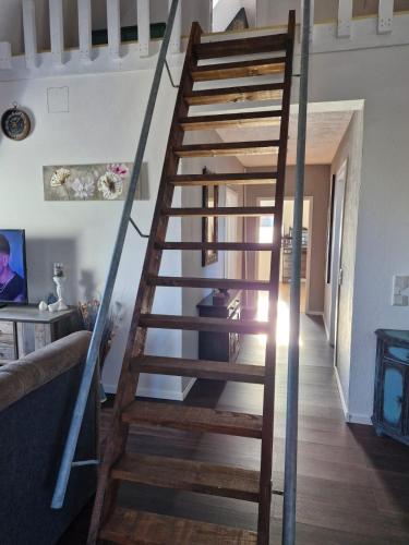 a wooden spiral staircase in a living room at Haus FayFay FerienMonteurApartment in Rüthen