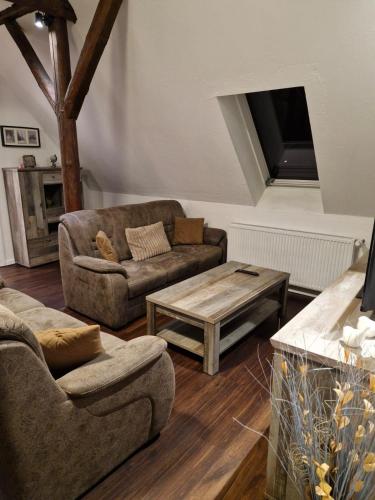 a living room with two couches and a coffee table at Haus FayFay FerienMonteurApartment in Rüthen