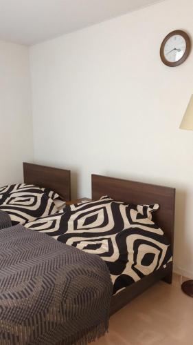 a bedroom with a bed and a clock on the wall at 1棟貸し Villa YOU hokkaido date toya in Date