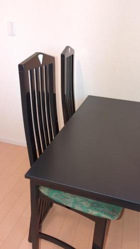 a black table and a chair with a black table at 1棟貸し Villa YOU hokkaido date toya in Date