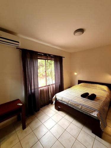 a bedroom with a bed and a window at Marina Loft Condos 223 in Coco