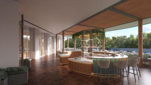 a patio with a bar with chairs and tables at Radisson Resort Khopoli in Khopoli