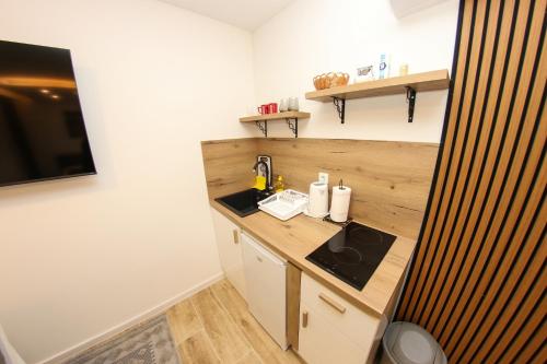 a small kitchen with a counter and a sink at Apartmani Moj MIR in Sarajevo