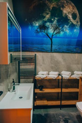 a bathroom with a sink and a tree on the wall at 7Sense Nature Resort in Sapanca