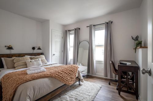 a bedroom with a bed and a desk and a mirror at Walkable to Everywhere in Little Italy- Near CWRU and Cleveland Clinic Main Campus in Cleveland