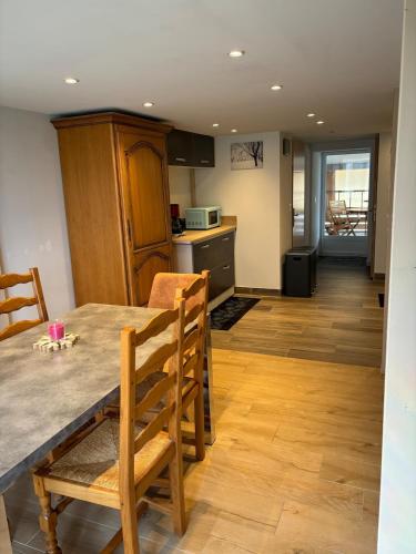 une cuisine et une salle à manger avec une table et des chaises dans l'établissement Gîtes entre 2 lacs, à Perret-Dessous