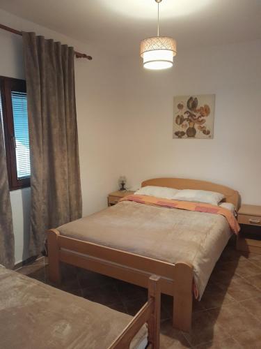 a bedroom with two twin beds and a window at Apartment Jelaca in Herceg-Novi