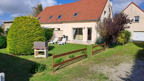 une maison avec une clôture dans la cour dans l'établissement Au bord de la mer, à Saint-Jean-de-la-Rivière
