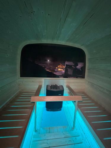 a small room with a table and a tv in it at Ski Lodge Pampeago in Tesero