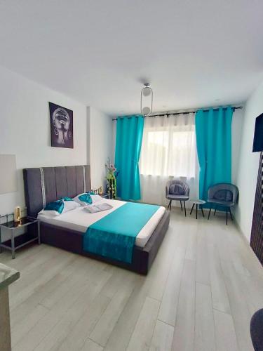 a bedroom with a bed and blue curtains at Eduard Elegance Rin Studios in Bucharest