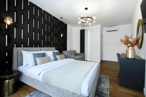 a bedroom with a white bed and a black wall at URBAN DOWNTOWN luxury rooms and suites in Belgrade