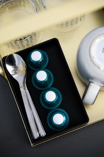 a black plate with green buttons on a table at URBAN DOWNTOWN luxury rooms and suites in Belgrade