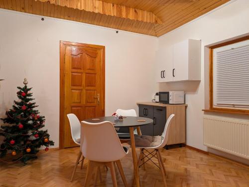 a kitchen with a christmas tree and a table and chairs at Солодка Мить in Slavske