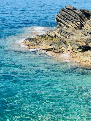 a large rock in the ocean next to the water at Al Castello 1 in Riomaggiore