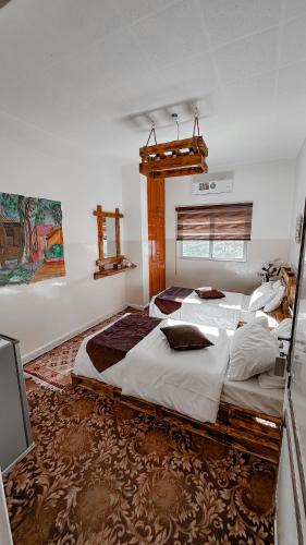 a bedroom with a large bed and a television at Petra Wooden House in Wadi Musa