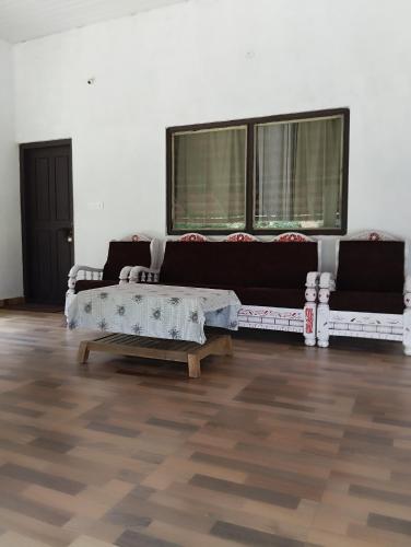 a living room with a couch and a coffee table at Creek Side in Madikeri