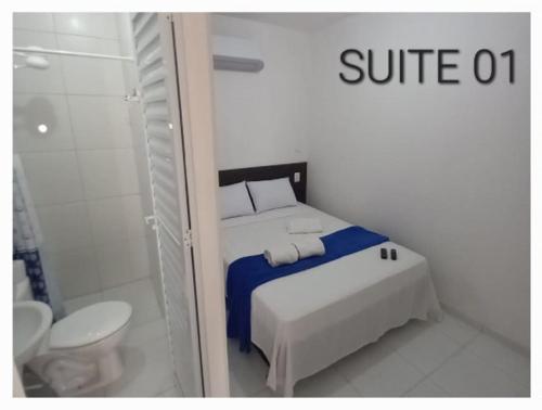 a bedroom with a bed and a shower and a toilet at Casa da Lalá in Fortaleza
