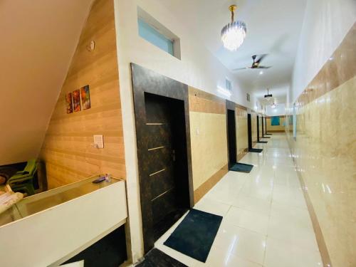 a hallway with a row of doors in a building at Hotel Vijay Greens in Orchha
