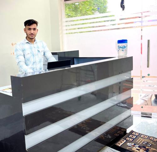 a man standing at a desk in an office at Shri Sarju Palace in Orchha