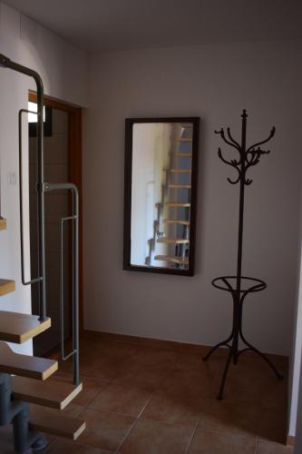 a room with a mirror and stairs and a table at Tücsi lak in Szigetszentmárton