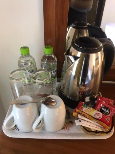 a shelf with a coffee pot and a tea kettle at Chaya Beach Hotel,Tangalle in Tangalle