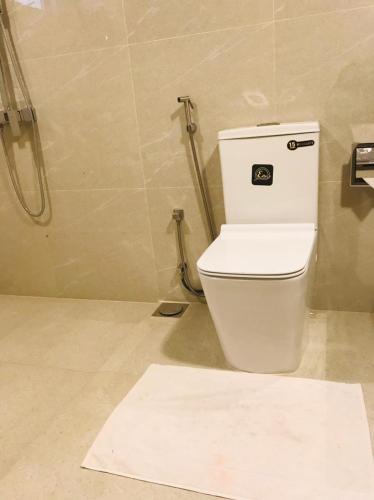 a bathroom with a toilet and a shower at Chaya Beach Hotel,Tangalle in Tangalle