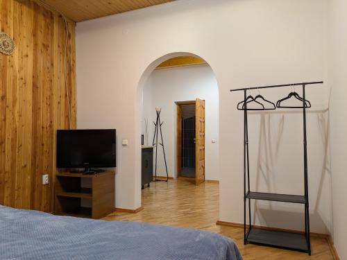 a bedroom with a bed and a flat screen tv at Солодка Мить in Slavske