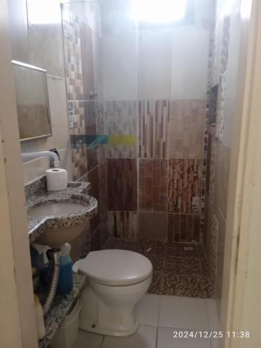 a bathroom with a shower with a toilet and a sink at Mini Recanto da Rosalina in Prado
