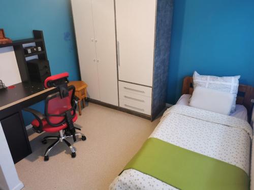 a bedroom with a bed and a desk and a chair at Maison entière - entire house in Differdange