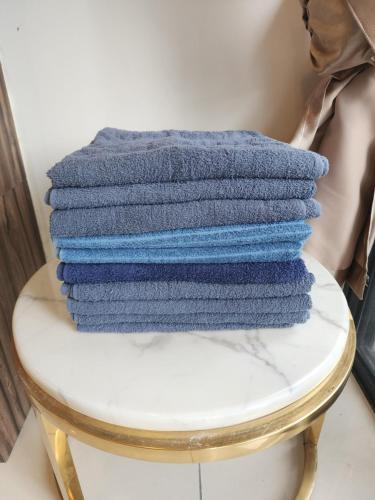 a stack of towels sitting on top of a stool at Astoria 4r3b 5minsklcc bathtub waterfilter newcondo bigbalcony in Ampang