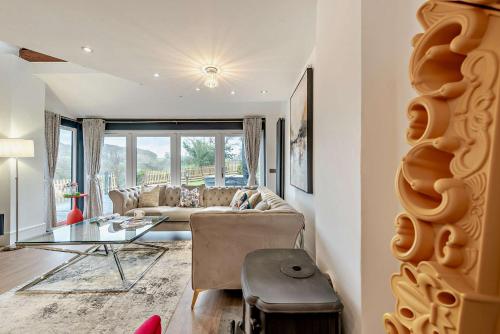 a living room with a couch and a glass table at The Tides in Pembrokeshire