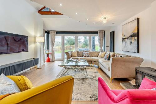 a living room with a couch and a table at The Tides in Pembrokeshire