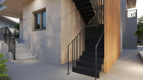 a staircase in a house with black railings at Maya Suites Potidaia in Nea Potidaea