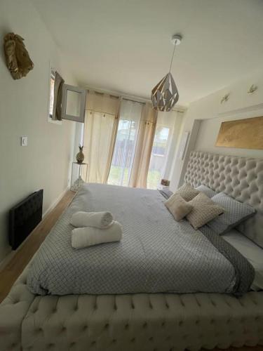 une chambre avec un grand lit avec deux oreillers dessus dans l'établissement Villa avec jardin et piscine, au Barcarès