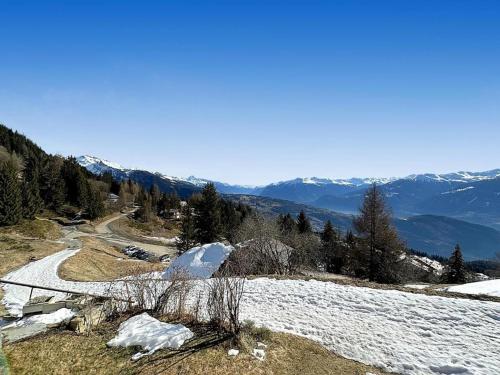 a snow covered hill with a road and mountains at Casa Salino in Salino