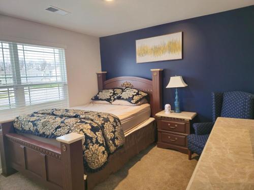 a bedroom with a bed and a blue wall at Elizabethtown Charm in Elizabethtown