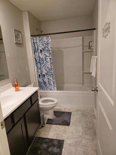 a bathroom with a toilet and a sink and a tub at Elizabethtown Charm in Elizabethtown