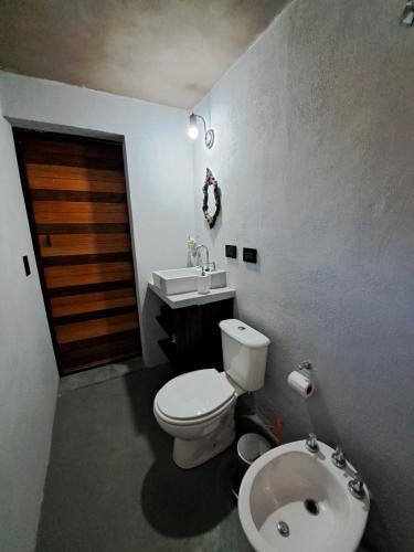 a bathroom with a toilet and a sink at Los Chivos in Villa Cura Brochero