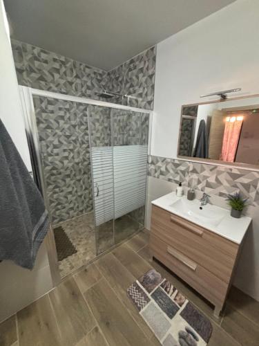 a bathroom with a shower and a sink and a mirror at El hondón del lugar 2 in Hoyos