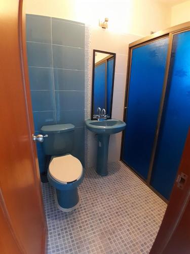 a bathroom with a toilet and a sink at Casa los fundadores 24 7 Security Private Pool Service Included in Playa del Carmen