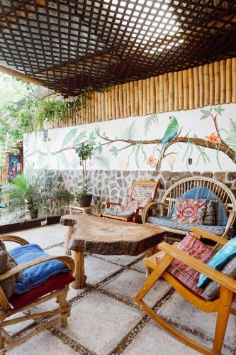 a room with chairs and a table and a bird on the wall at Casa Mike, San Marcos La Laguna in San Marcos La Laguna