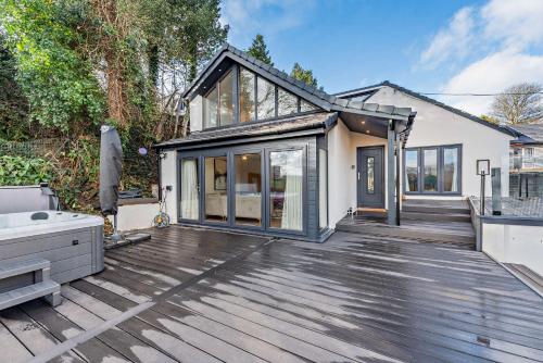 a home with a wooden deck with a house at The Tides in Pembrokeshire