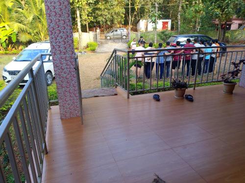 a group of people standing behind a fence at Parvati Narayan Guest House in Sānikatta